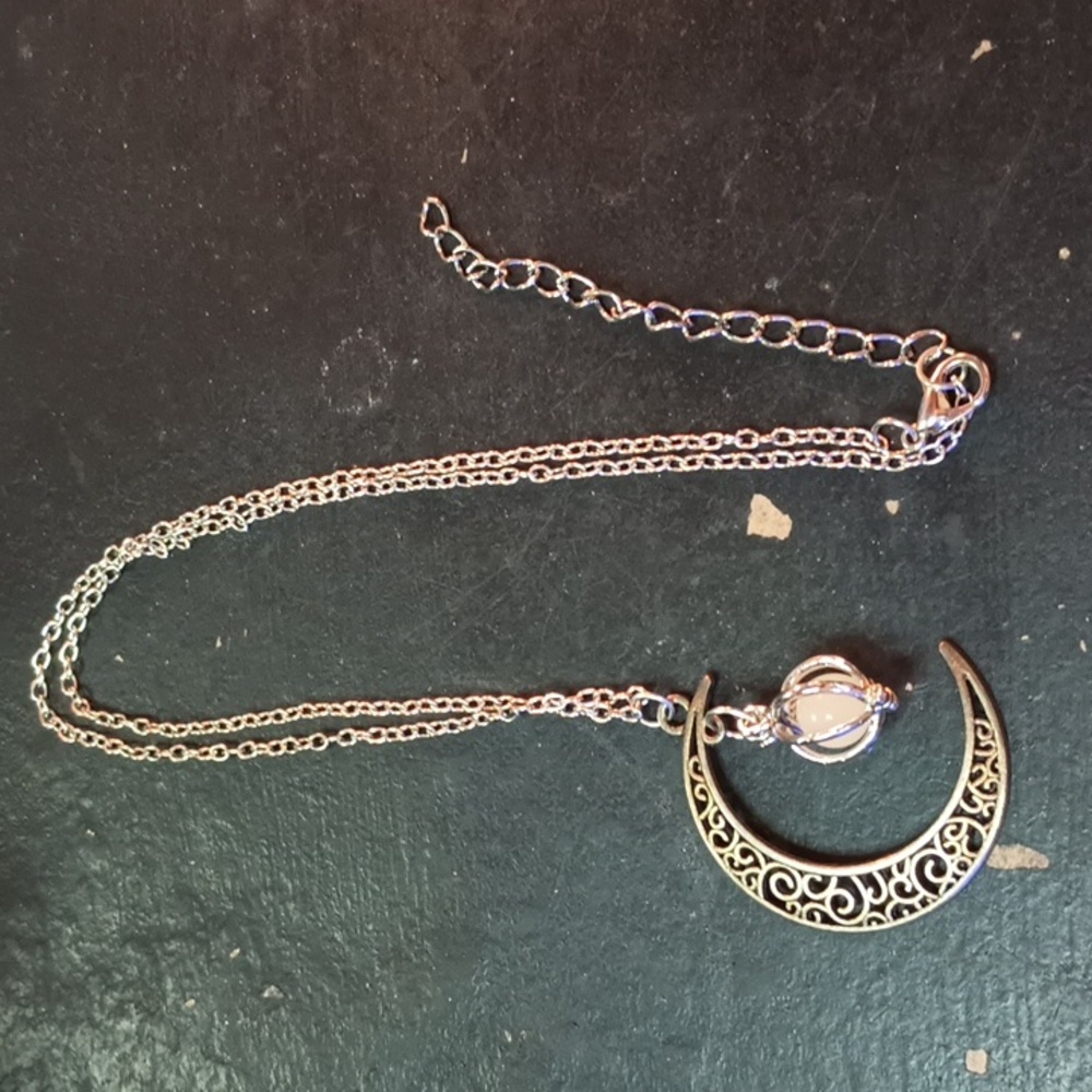 Silver moon necklace with glow in the dark ball in the middle
